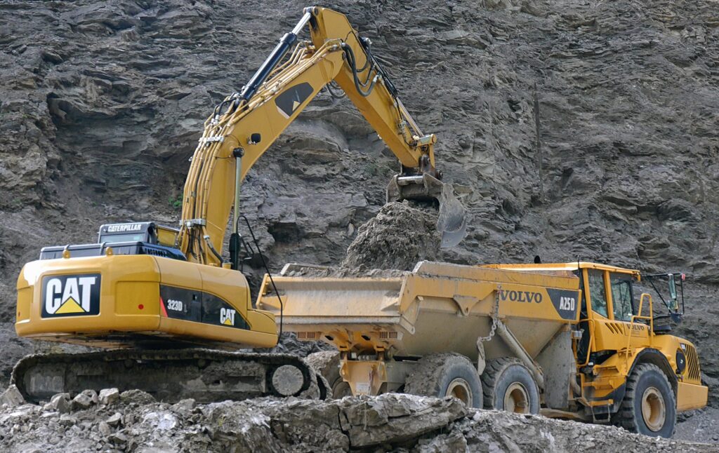 Excavator loading ore in a mine truck